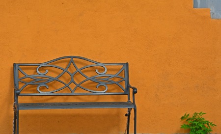 Bench against orange wall